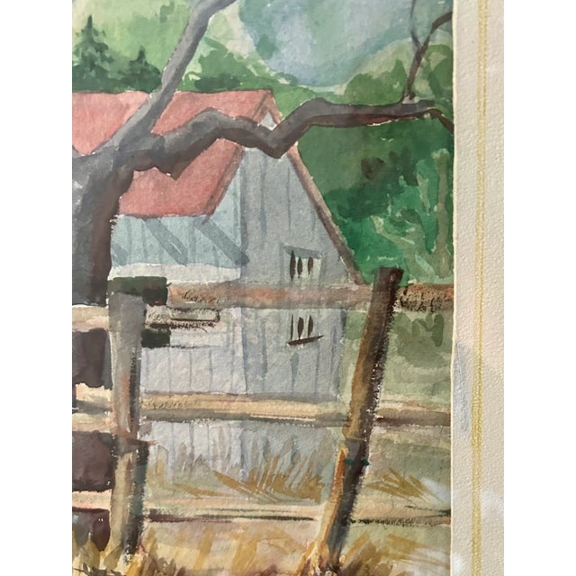 Original watercolor painting of a white farmhouse with a red roof set behind a rustic post and beam fence with rolling...