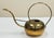 Vintage sculptural brass watering can. Sophisticated curved leg attaches to rounded body with domed handle. Marked to...