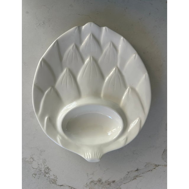 This set of six artichoke-form ceramic plates immediately stood out for their sculptural presence and timeless design....