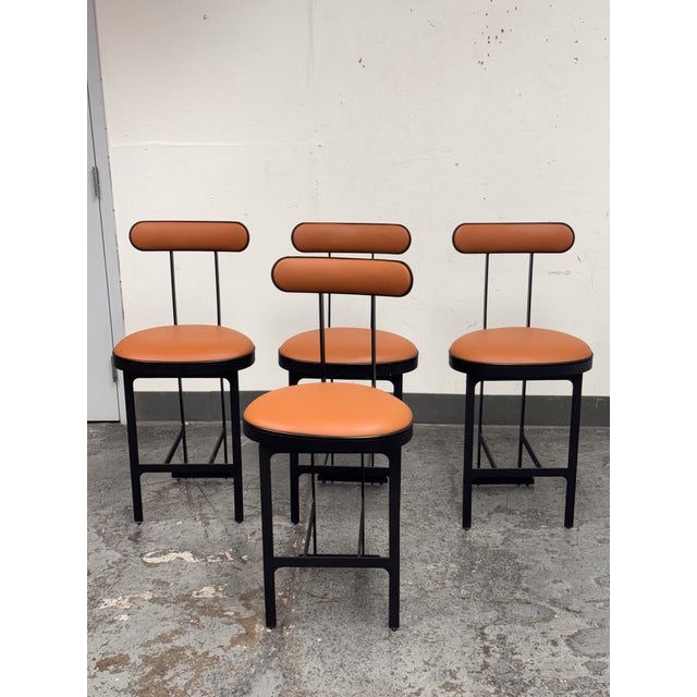 Design Plus Gallery presents a Set of Four Custom Design Swivel Faux Leather Counter Stools from Michael Oren Design. In...
