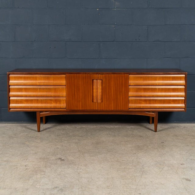 A handsome mid-century teak sideboard by elliots of newbury (eon), one of britain's most respected post-war furniture...