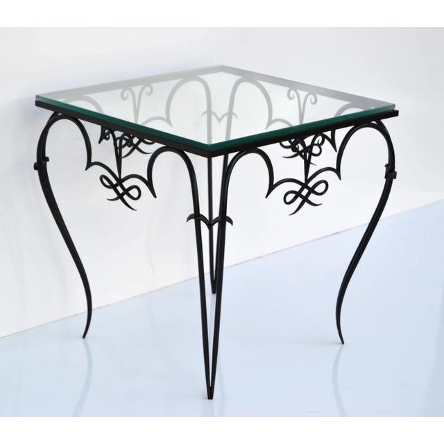 Whimsical Art Deco René Prou style black wrought iron & glass top side or end table made in France in the late 1940. Ready...