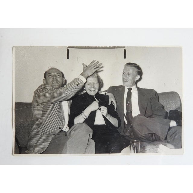 Mid 20th century snapshot photograph of two men and woman being silly at a party. Unframed, edges trimmed, scattered...