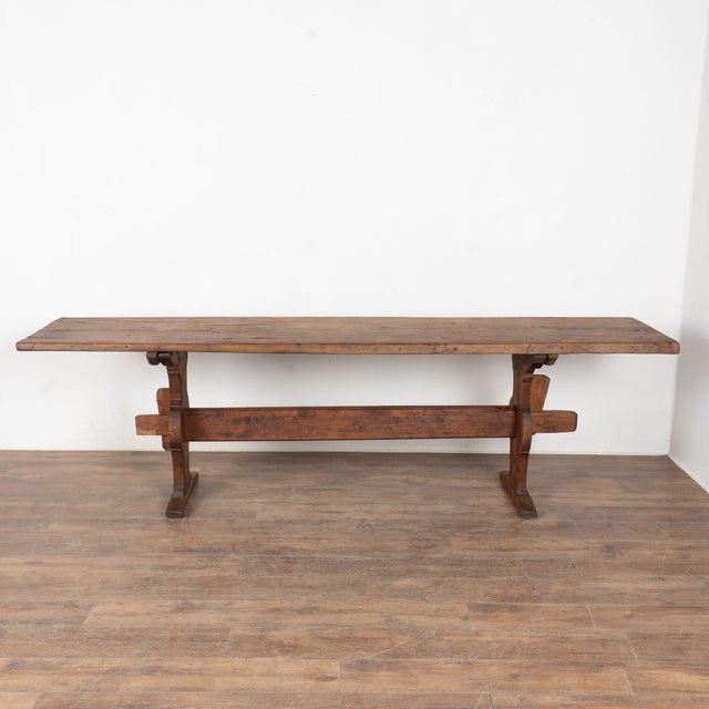 Early 19th century Swedish console table, crafted in pine with a dark aged patina. The table stands on a traditional...