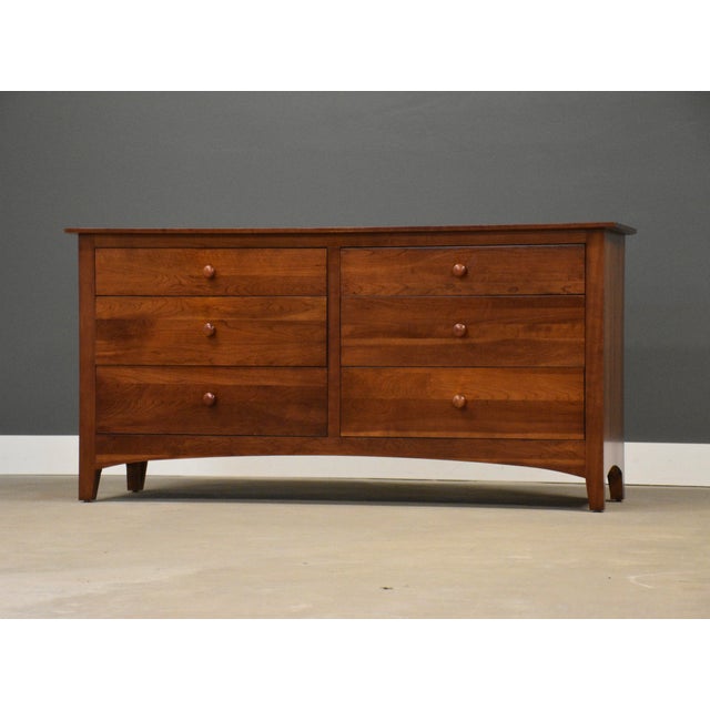 A six drawer solid cherry dresser with round knobs made by Ethan Allen American Impressions. Dovetail drawers. Made in...