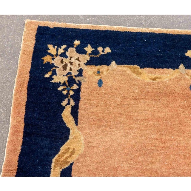 Chinese Art Deco Wool Rug, with floral garland motif on blue and red ground. 3' 8.5" L x 1' 11.5" W. Provenance: From a...