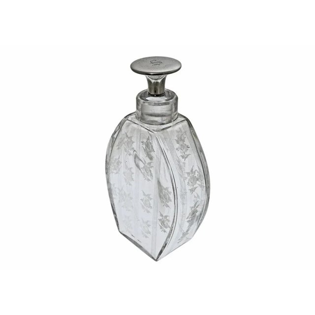 American H.P. Sinclaire & Co. (active 1904–28) pair of engraved clear glass decanters and sterling mount stoppers. They...