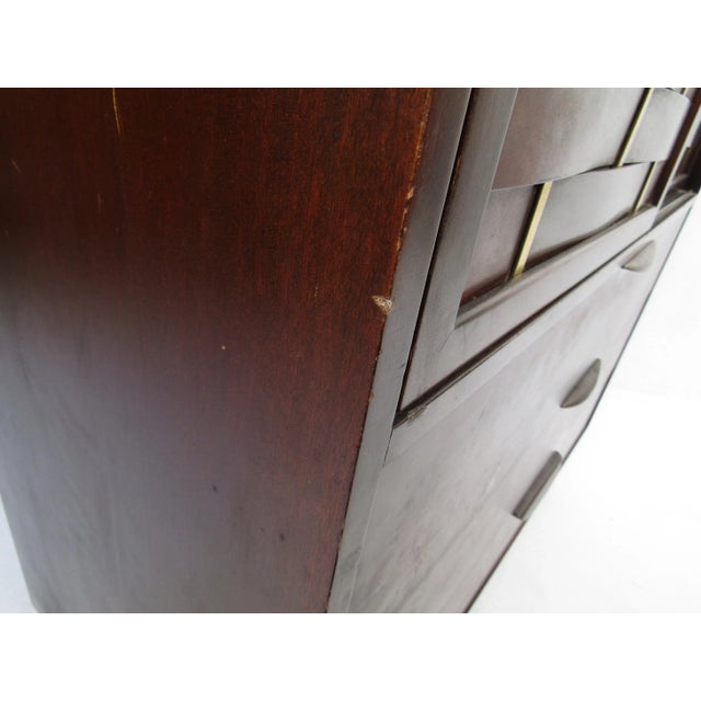 Handsome Mid-Century Modern highboy dresser designed by Harvey Probber. Dark mahogany exterior throughout. The cabinet...