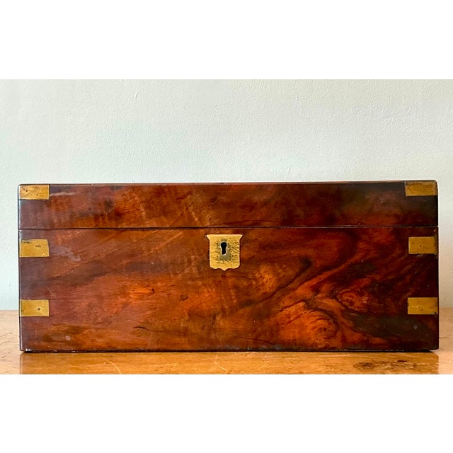 Evoke the golden age of travel and correspondence with this magnificent antique campaign-style writing box. A superb...