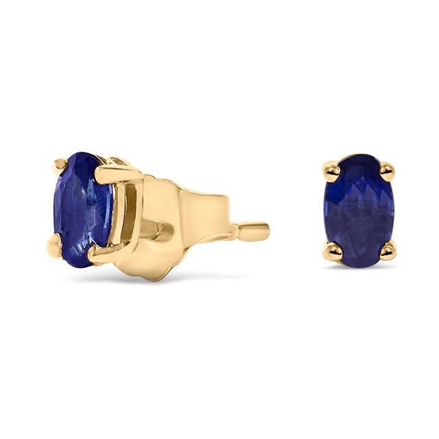 Immerse yourself in the splendor of these resplendent stud earrings, each adorned with a natural, oval-cut blue sapphire,...