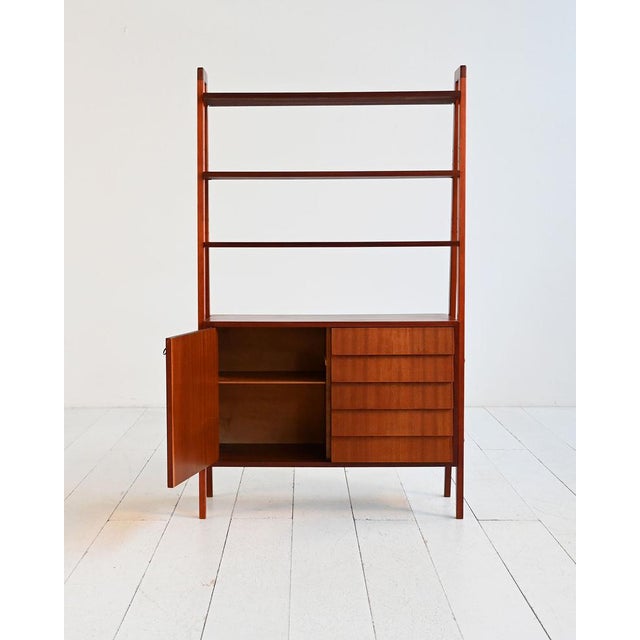 Mahogany structure with open shelves and a storage compartment with a hinged door and a chest of drawers. Scandinavian...