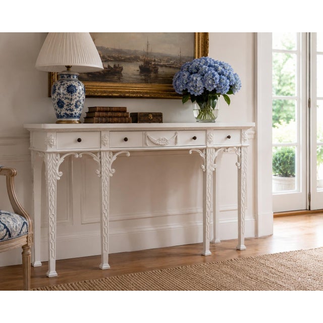 An elegant Maitland-Smith console table in the Chippendale taste, featuring finely carved mahogany construction finished...