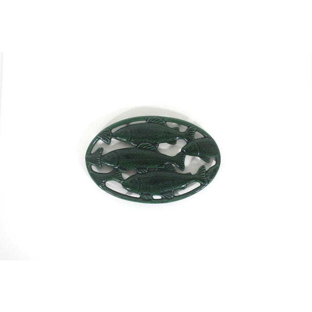 This beautiful French trivet is gorgeous! Dark green enamel over cast iron in an oval shape with fish (maybe trout) and...
