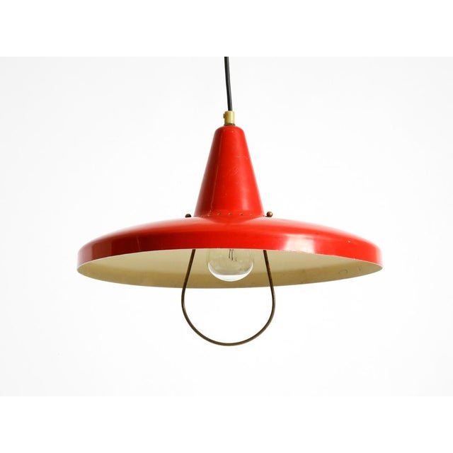 Beautiful red Mid-Century Modern pendant lamp. Height-adjustable by a counterweight. Made in Italy. Great, typical 1950s...