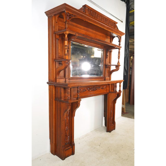 Neoclassical style antique oversized fireplace mantel carved from Cherry Wood with a natural aged finish. Acquired from...