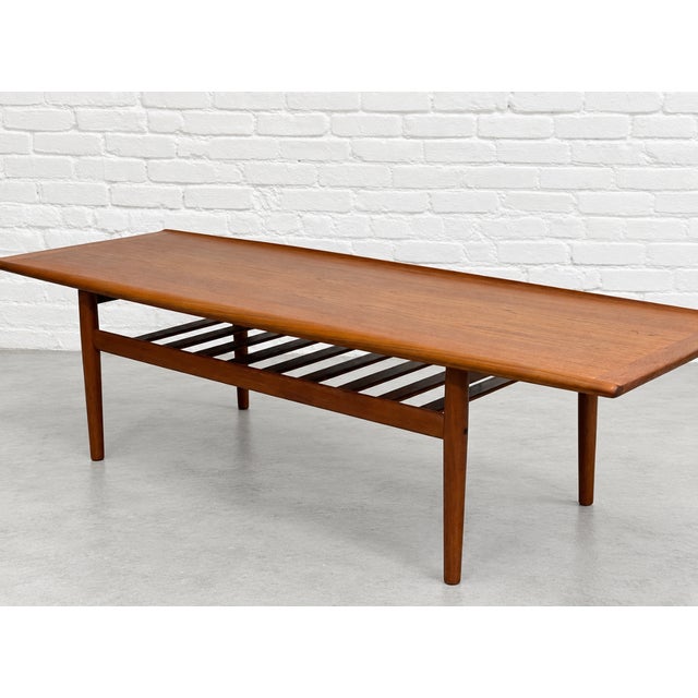 Mid Century Modern Teak Coffee Table by renowned Danish designer, Grete Jalk, c. 1960’s. This stunning coffee table...