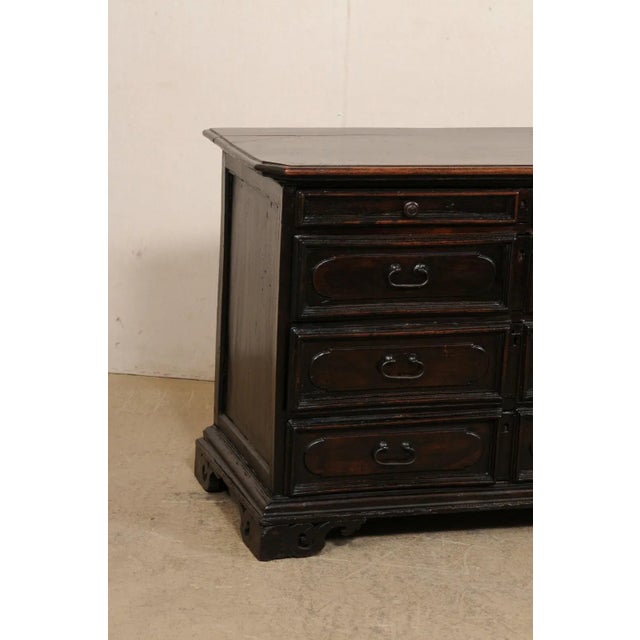 An exceptionally handsome Italian chest of four drawers from the early 18th century. This antique cassettiera (chest of...