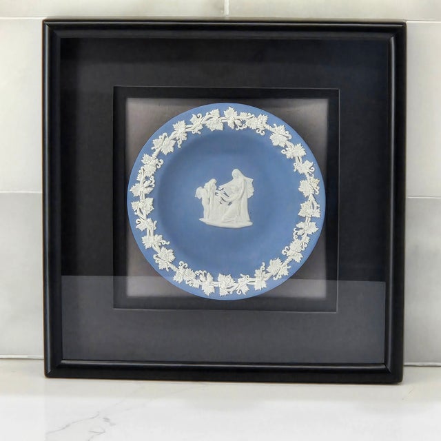 This Wedgwood Jasperware wall piece features a classic pale blue medallion plate with creamy white relief of a...
