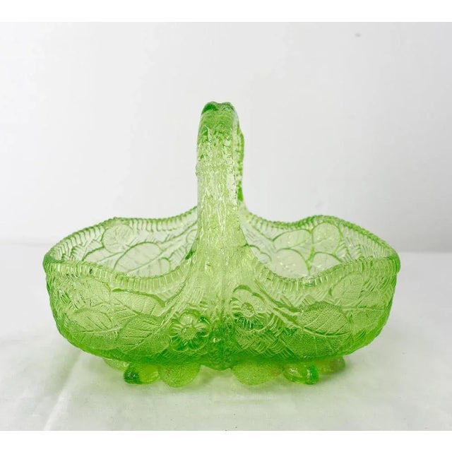 French green molded glass basket, to be used as a center piece or empty pocket. Decorated with vegetal and floral motifs...