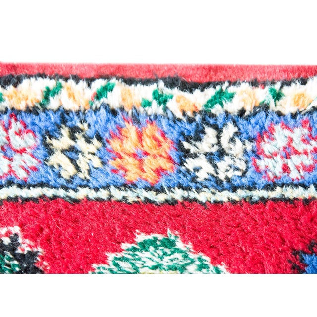 A vintage petite Moroccan rug with bold geometry and saturated color, woven with a large central green diamond medallion...