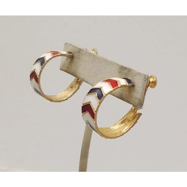 This is part of Chairish’s Costume Jewelry assortment. 1960s goldtone chevron design white enamel with alternating red and...