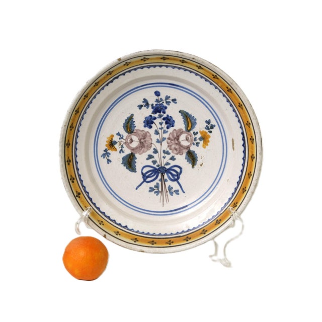 A late 18th-century poly chrome painted deep plate in shades of deep cobalt, yellow, green and an unusual purple. The...