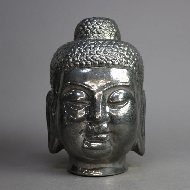 A Tibetan bust offers silver gilt ceramic bust of Buddha, 20th century Measures - 13''H x 8''W x 8.5''D.