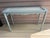 Lovely hand carved wood console table with an etched glass top. Painted in a serene blue gray. A fancy rustic look!