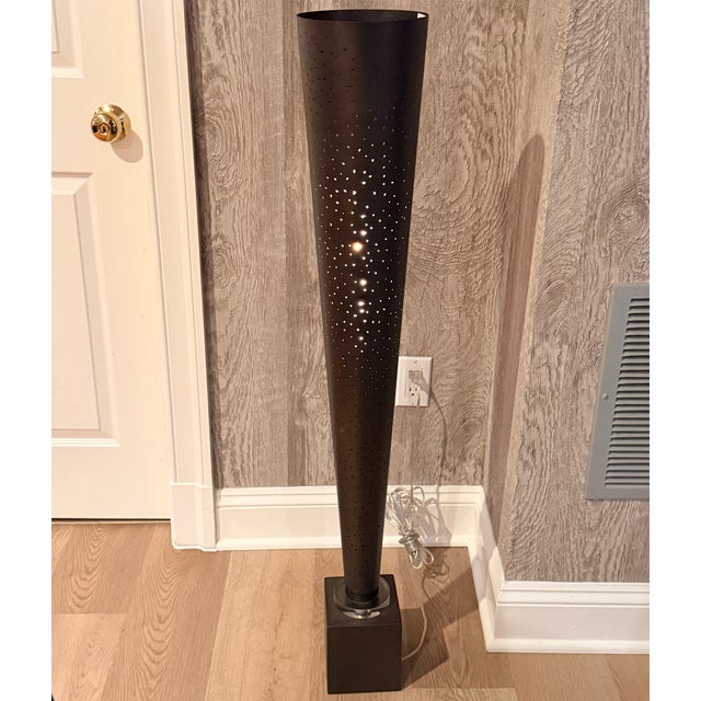 Uttermost Celeste Torchiere A tall dark bronze cone with laser perforations on a cubed base. Suitable for floor or on a...