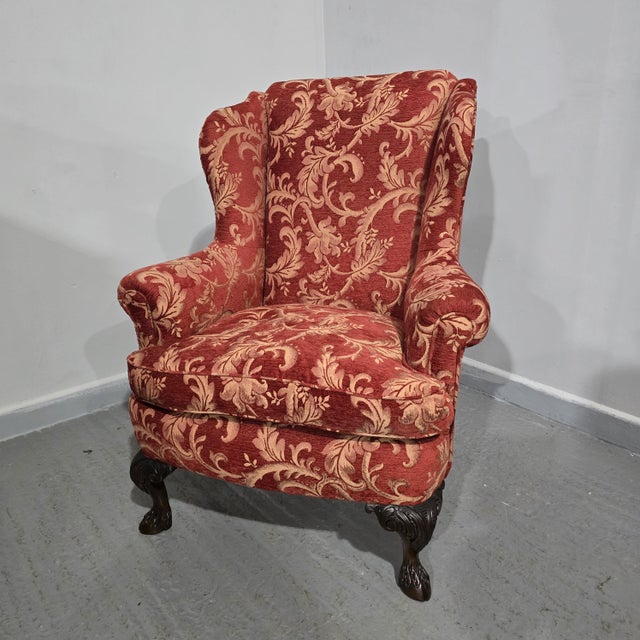 In excellent overall condition, mahogany wing backed chair, with feather filled cushion and wonderful goat hoof legs. 39"...