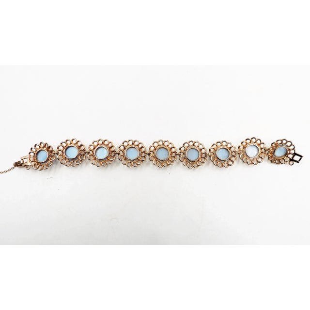 1950s goldtone cabochon faux-blue moonstone rhinestone bracelet with fold over clasp and security chain. Unmarked Reja....