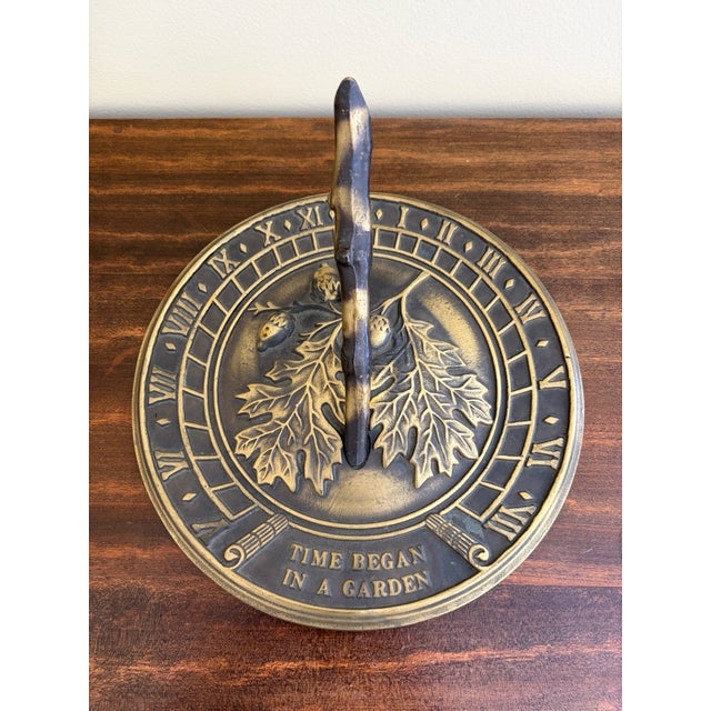 A stunning vintage cast iron garden sundial featuring acorns, oak leaves, and Roman numerals with the phrase, "Time began...