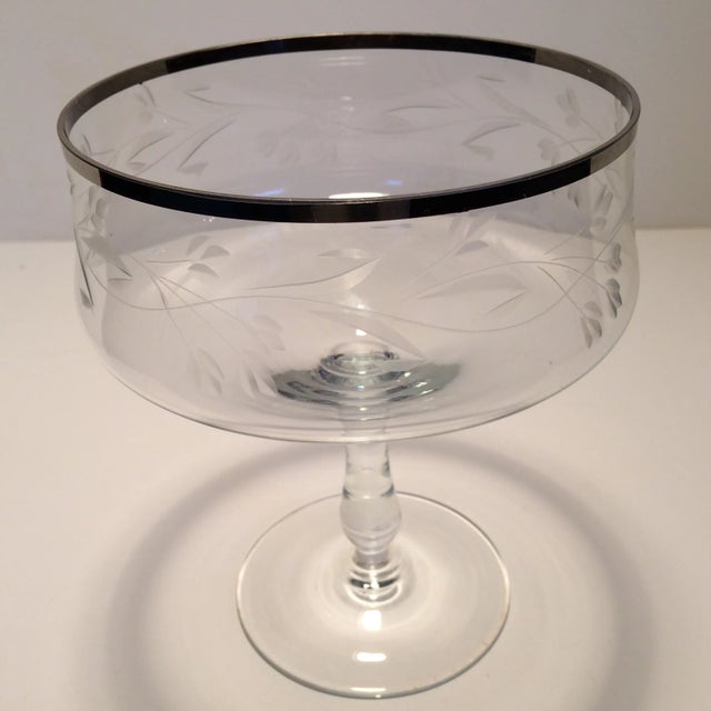 Beautiful pedestal crystal dish with etched floral design and platinum rim.