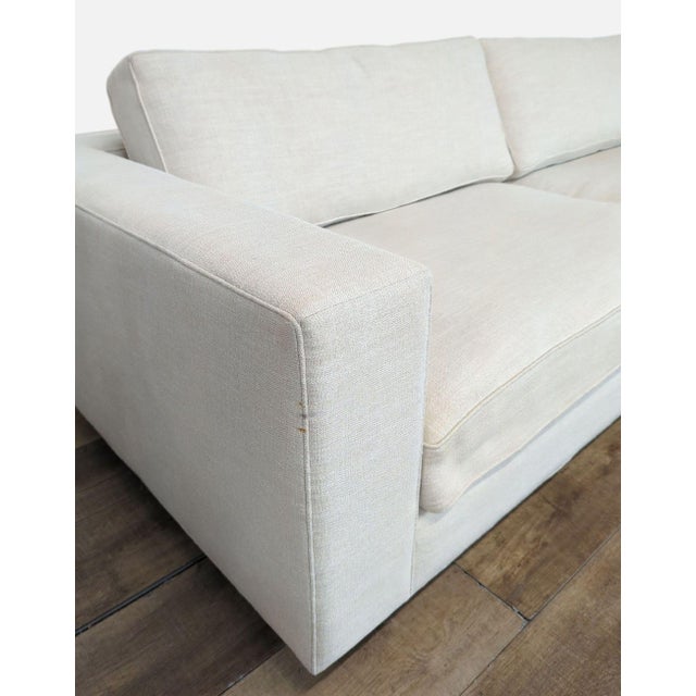 Features neatly piped seat and back cushions flanked by clean track arms. Dimensions (in): 108W x 46D x 25H.