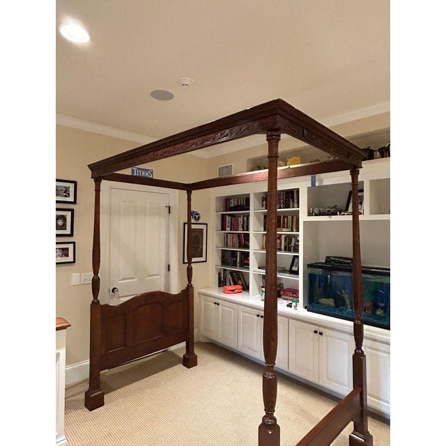 An exquisite specimen of an antique, American four poster canopy bed featuring beautiful carved details on the tester,...