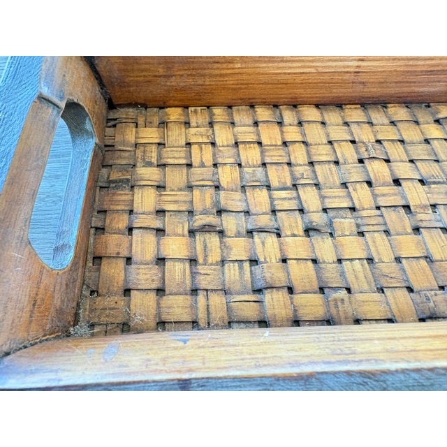 Beautiful vintage handcrafted wooden tray featuring a warm, naturally aged finish and a woven splint base. The long,...
