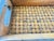 Beautiful vintage handcrafted wooden tray featuring a warm, naturally aged finish and a woven splint base. The long,...