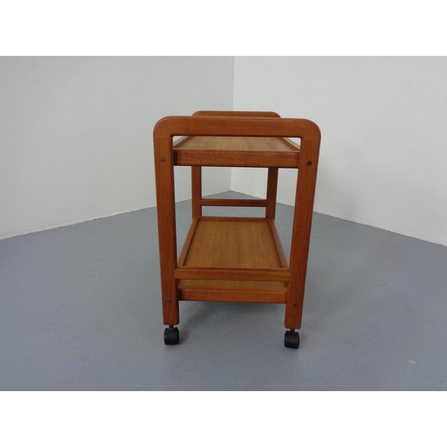Rollable, teak tea or serving car with removable tray from the 1960s.
