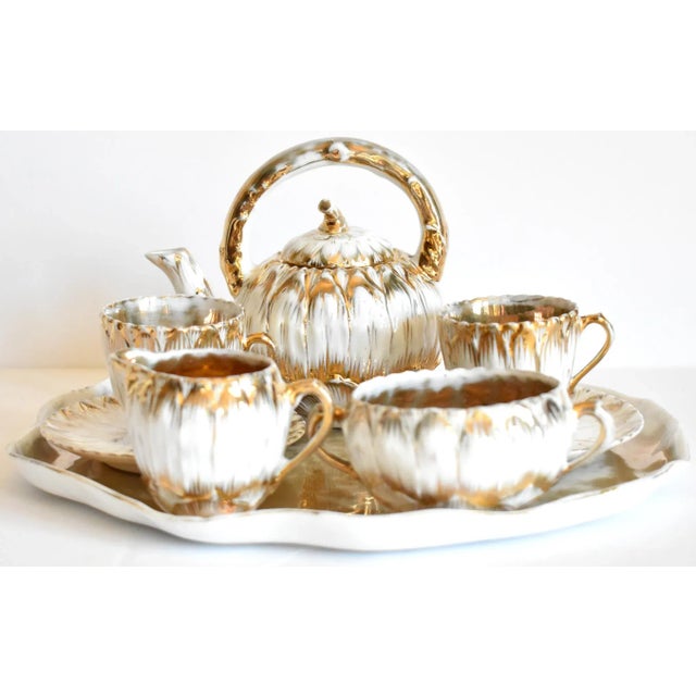 An antique, Victorian white porcelain demitasse small tea service in trompe l'oeil zinnia or daisy flower petals and stems...