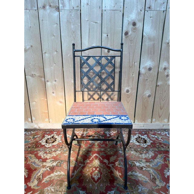 Set of six high-backed garden chairs, handcrafted in the 1980s-1990s, wrought iron with cement mosaic seats. The backrest...