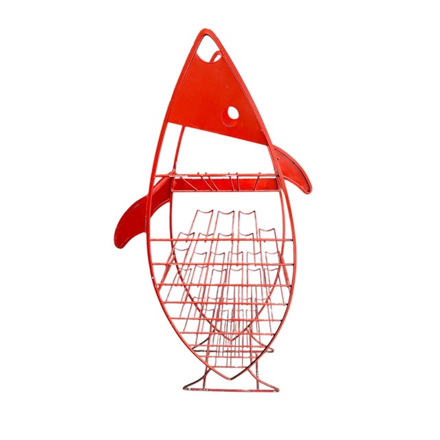 French mid century wine bottle holder in the shape of a fish. Painted red. Heavy metal. Holds 39 bottles of wine.