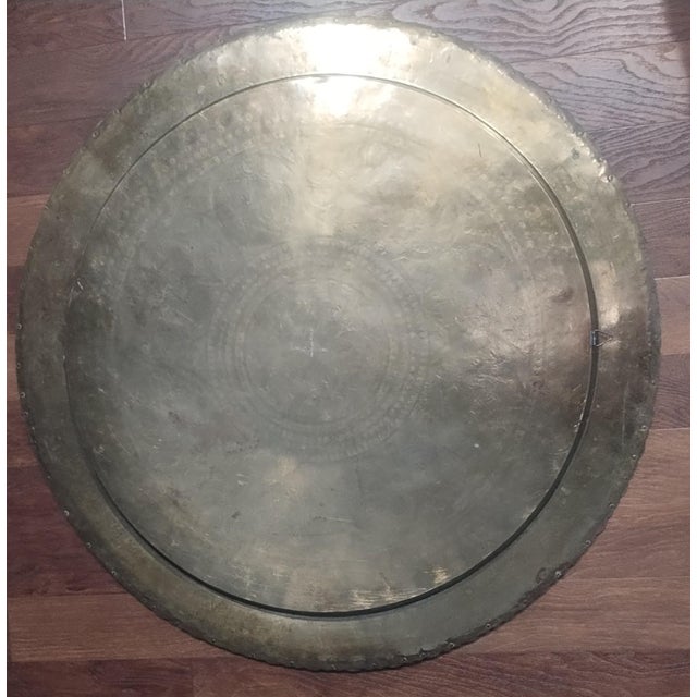 Gorgeous large brass tray with hanger on back Heavy. Weighs over 7 lbs. 30 inch diameter Made in Hong Kong Scalloped edge...