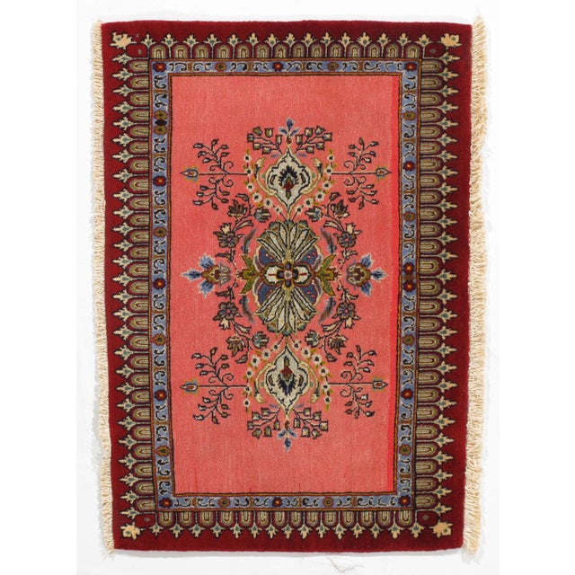 Vintage hand-knotted Persian Qom wool rug on a silk foundation, featuring a coral field with a central medallion and...