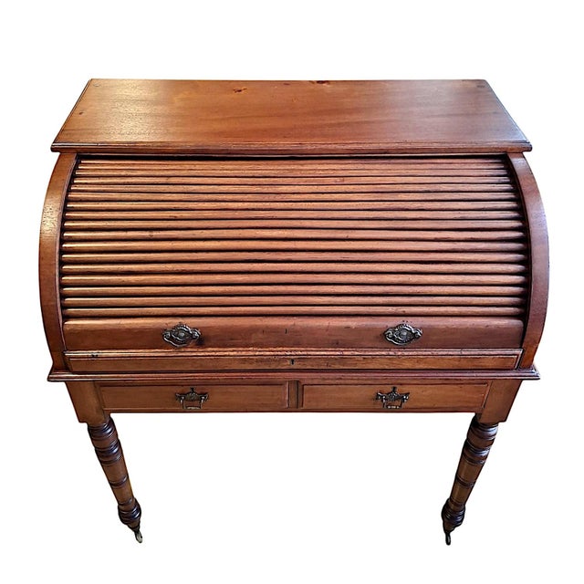 This Victorian roll-top desk is a highly functional and beautifully crafted piece of late 19th-century furniture....