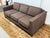 Design Plus Gallery presents a Brown Sofa with Contrast Trim from Mitchell Gold + Bob Williams. The sofa has a dark brown...