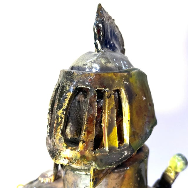 This unique brutalist r pottery torso figure of a "Dark Knight" features an intricate design that has been glazed through...