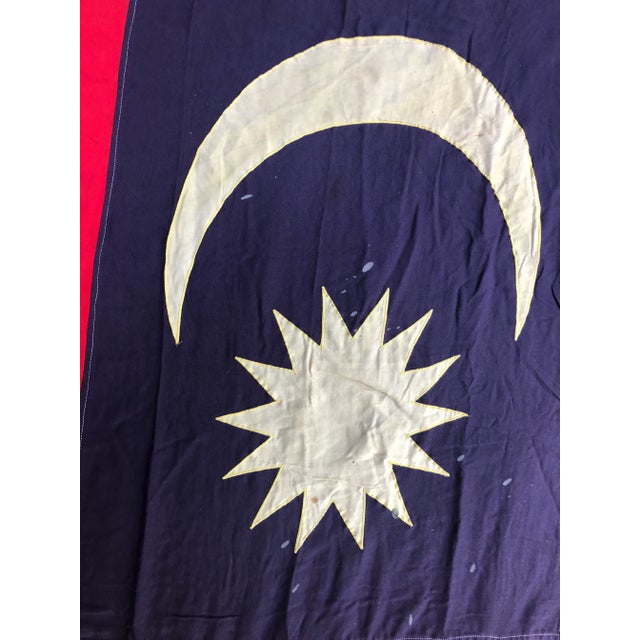 A large cotton nautical flag of Maylasia, salvaged from a ship where it was flown regularly. Crescent moon and sun are...