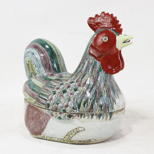 This stunning vintage Chinese porcelain covered bowl is expertly sculpted into the form of a seated rooster, serving as a...
