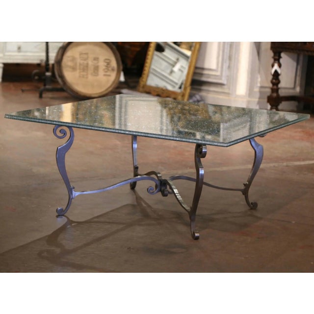 This vintage French coffee table, crafted circa 1970, showcases a refined blend of sculptural ironwork and textured glass,...