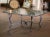 This vintage French coffee table, crafted circa 1970, showcases a refined blend of sculptural ironwork and textured glass,...